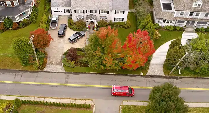 Cottam Heating & Air Conditioning Westchester HVAC service truck driving down the road of a neighborhood